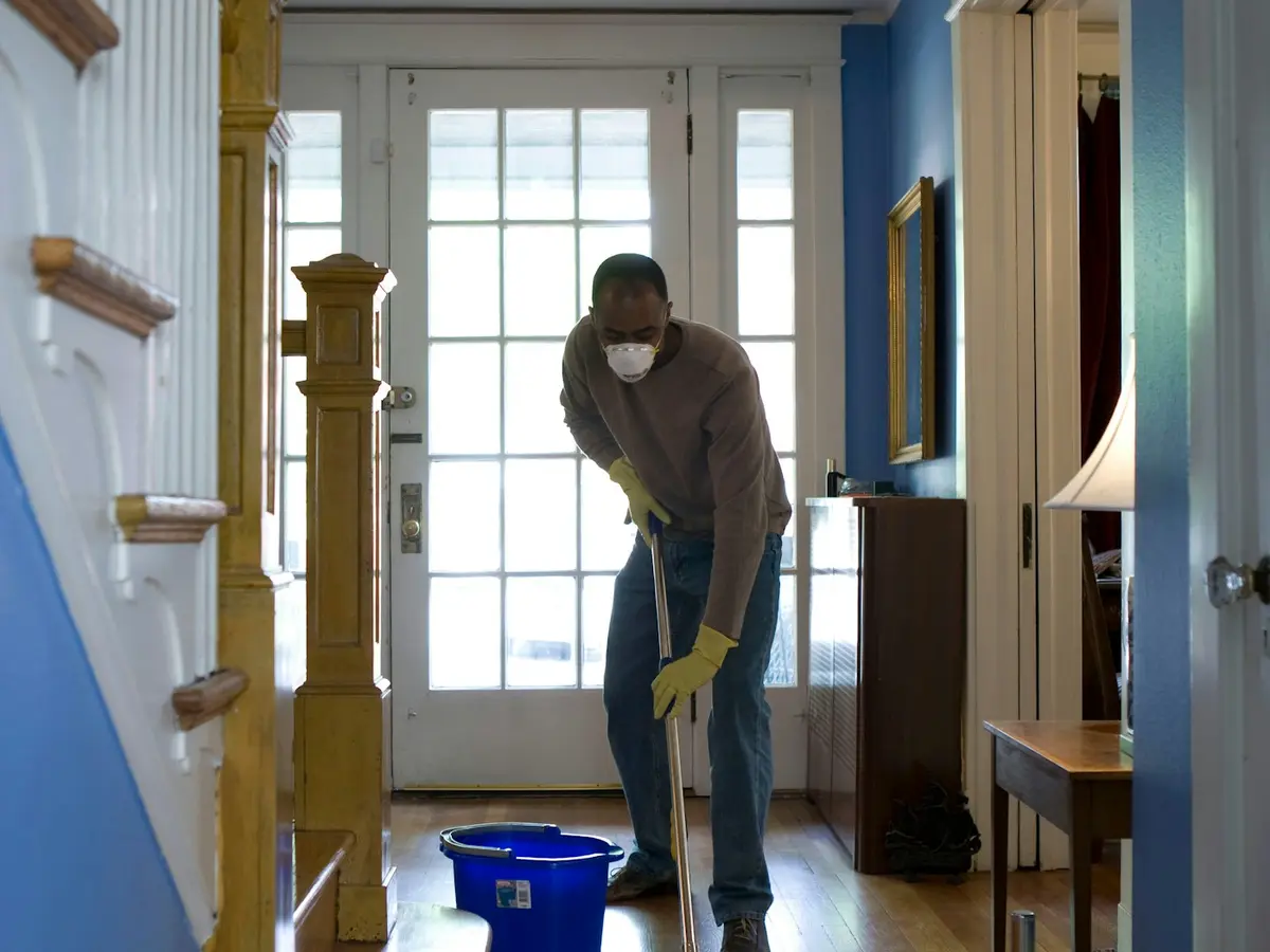 Cleaner wiping a condo kitchen counter
